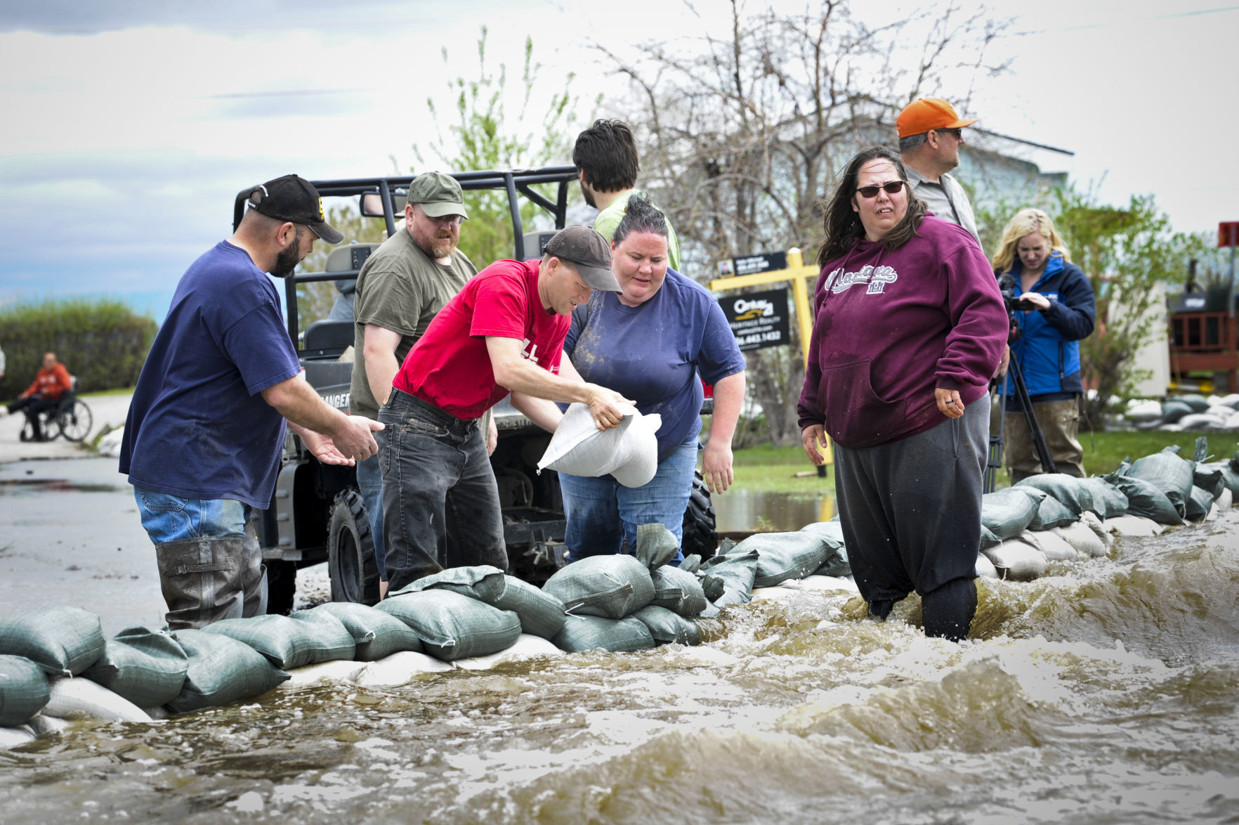 Residents and volunteers fight to divert flood waters in the Helena Campground and RV Park Monday.